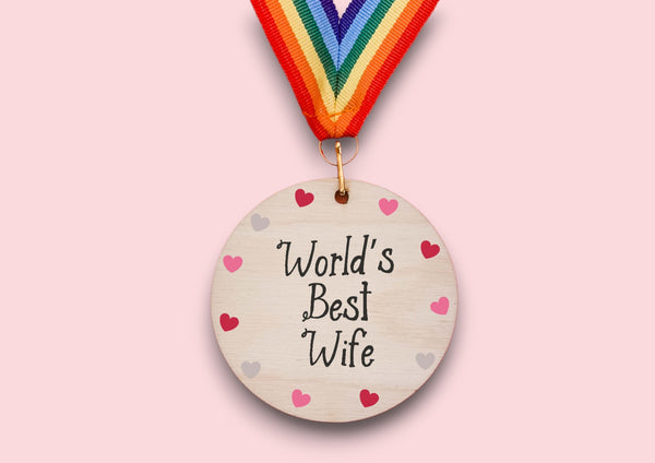 a wooden medal with a colorful ribbon around it