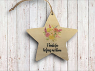 a wooden star ornament with a floral design