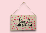 a wooden sign that says love is all around