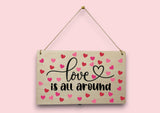 a wooden sign that says love is all around