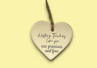 a heart shaped ceramic ornament with a message