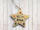 a wooden star ornament that says, you are a star