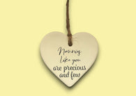 a ceramic heart hanging on a string