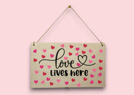a wooden sign that says love lives here
