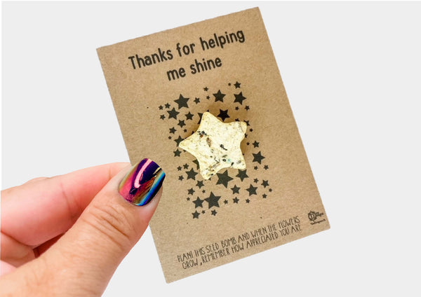 a hand holding a card with a star design on it