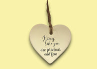a heart shaped ceramic ornament with a message