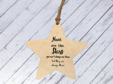 a wooden star ornament hanging from a string