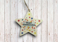 a wooden star ornament hanging on a wooden wall
