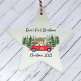a ceramic star ornament with a red car and a christmas tree on it