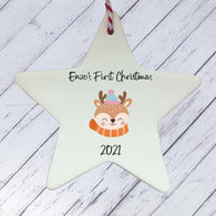 a white ceramic star ornament with a reindeer on it