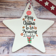 a white ceramic star ornament with a merry christmas message