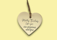 a heart shaped ceramic ornament with a message