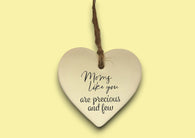 a white ceramic heart hanging on a string