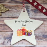 a white ceramic star ornament with presents on it
