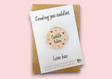 a card with a button saying sending you cuddles