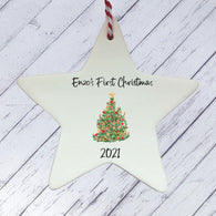 a ceramic star ornament with a christmas tree on it