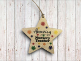 a wooden star ornament with the words amazing nursery teacher on it