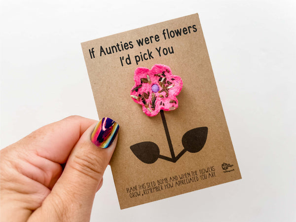 a hand holding a card with a flower on it