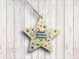 a wooden star ornament with the words super nursery teacher on it